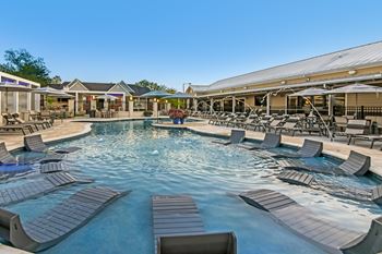 A large outdoor pool surrounded by lounge chairs